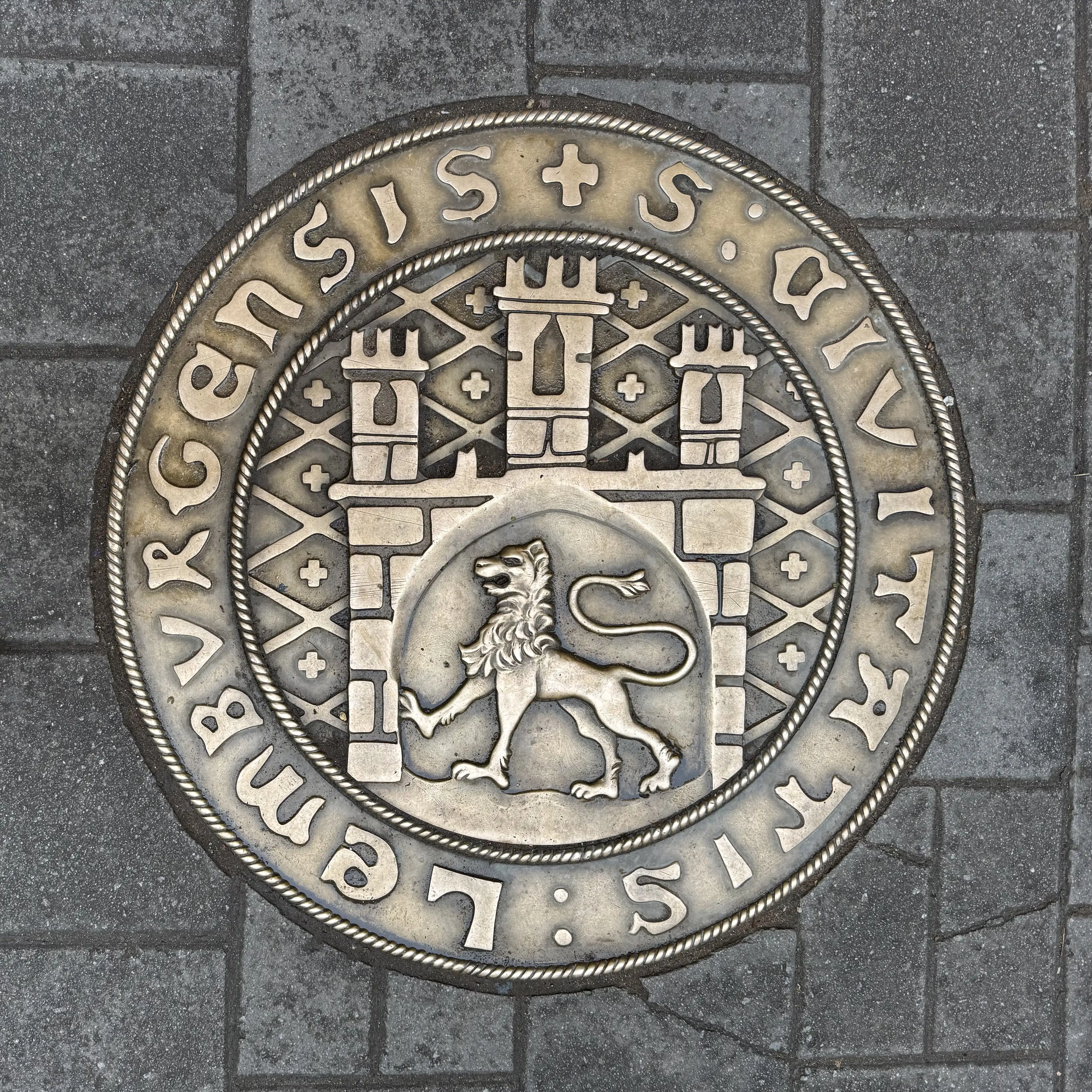 Historic city seal medallion on cobblestone in Lviv, Ukraine